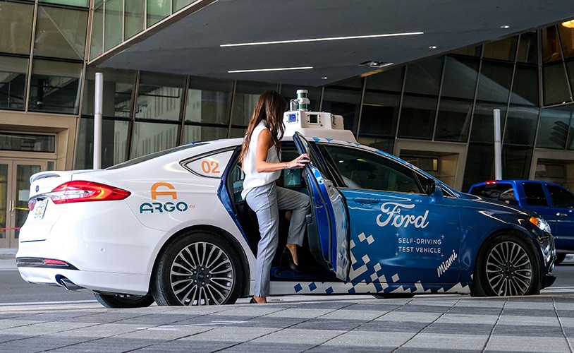 Photo of woman getting into autonomous driving vehicle
