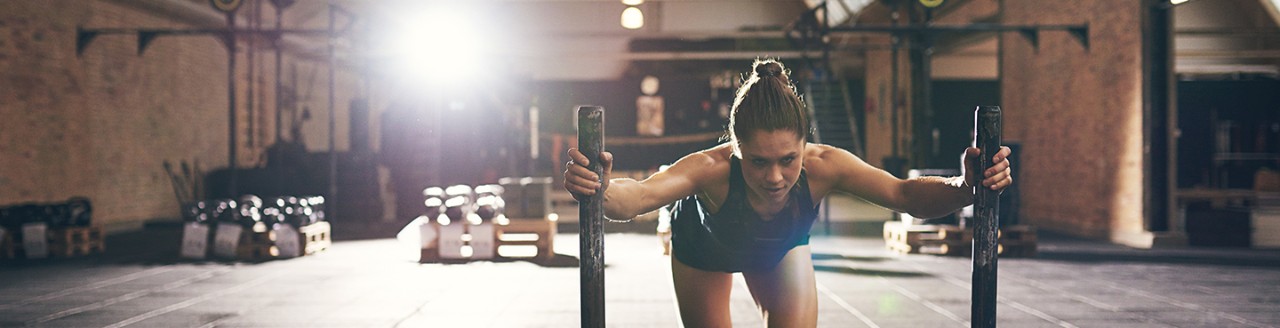 Woman working out in warehouse Gym