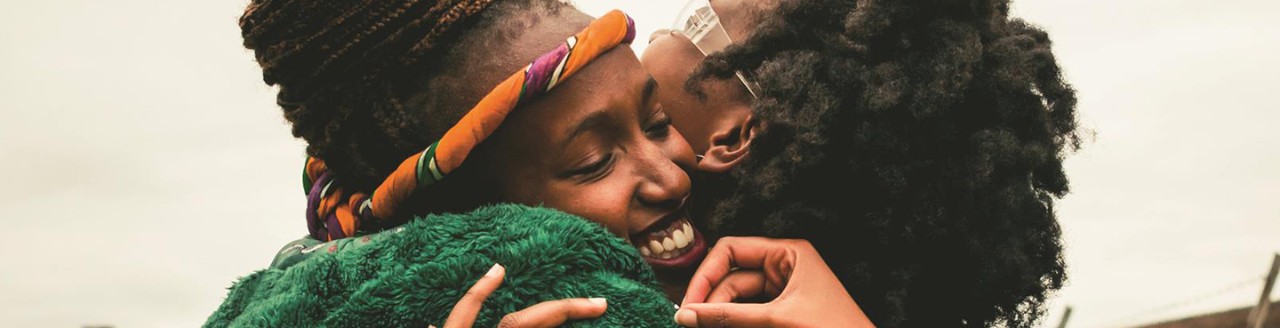 Two women hugging and smiling