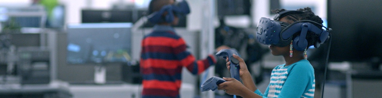 Little girl and little boy play augmented reality video games
