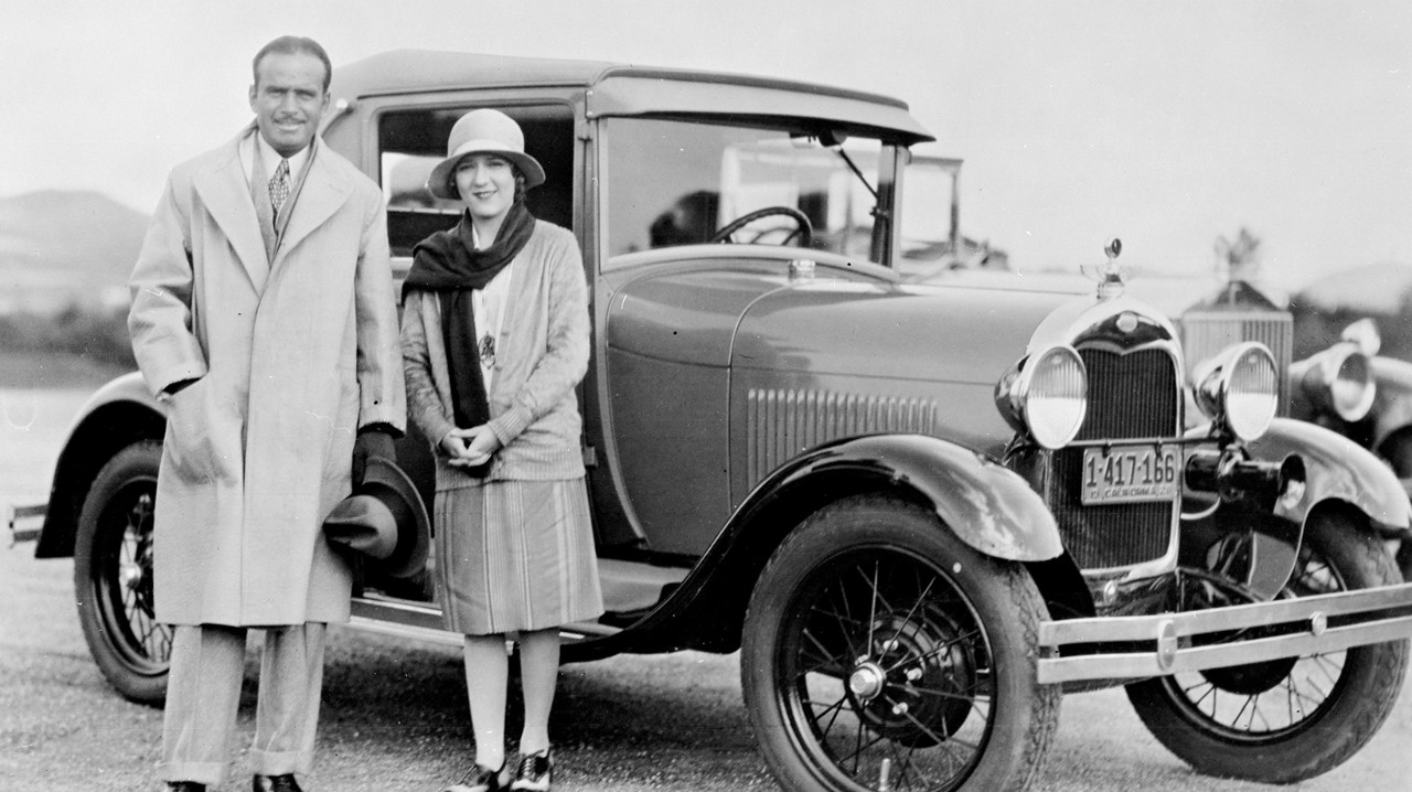 Doug Fairbanks and Mary Pick with a 1928 Ford Model A Sport Coupe A black and white photo of Doug Fairbanks and Mary Pick with a 1928 Ford Model A Sport Coupe