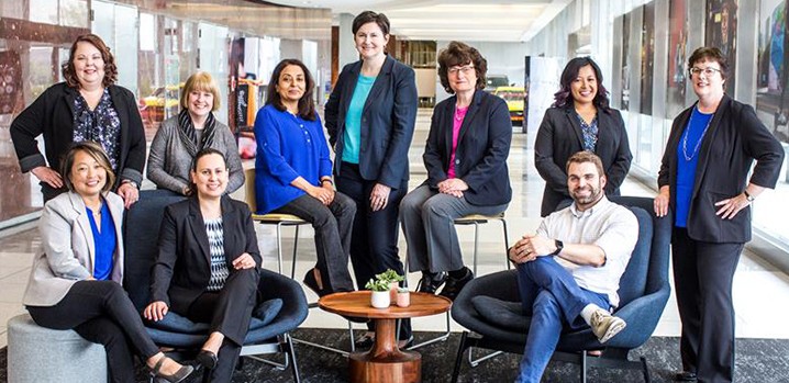 Group of colleagues pose for camera