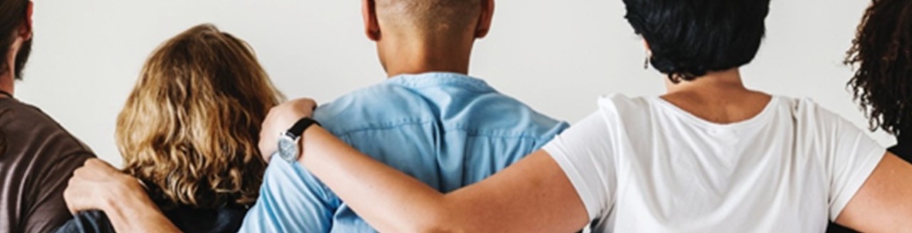 Image of the backs of 5 people with arms over each others shoulders