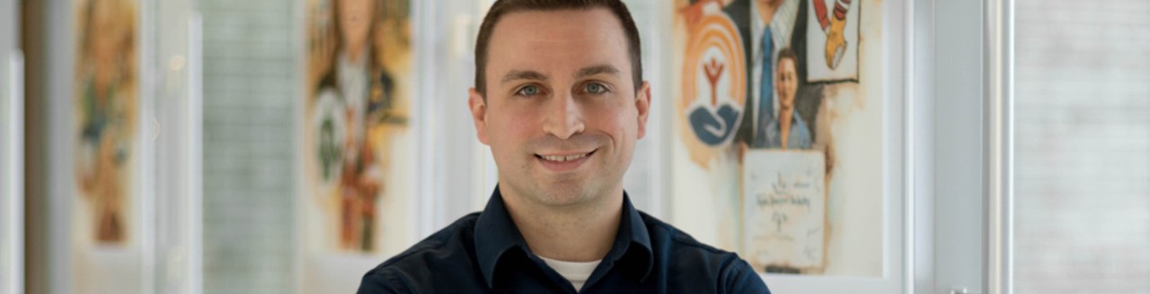 Male employee smiles for camera
