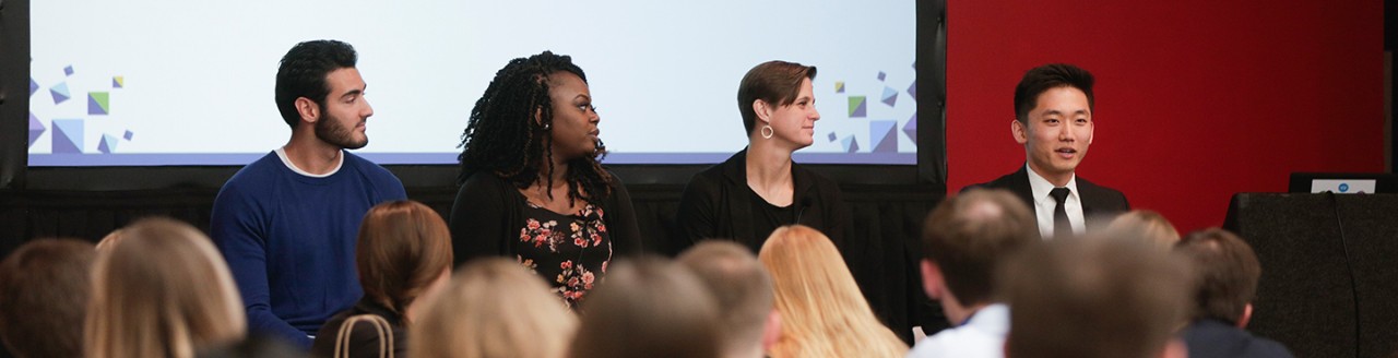 two men and two women speaking at a conference