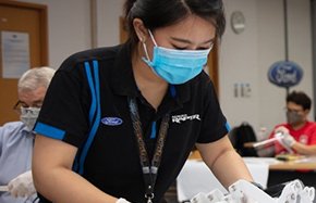 young woman wearing mask making personal protection equipment