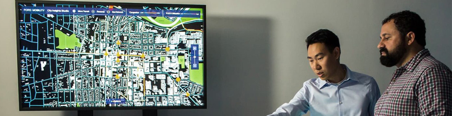Two men observing the City Insights Studio
