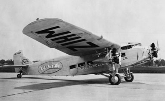 A black and white photo of a Ford Trimotor airplane
