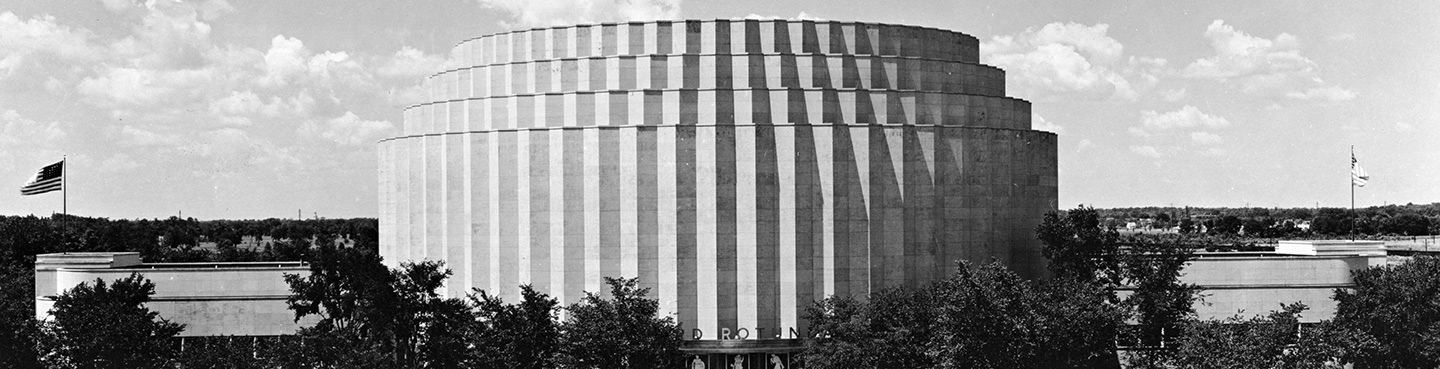 A black and white photo of a round building the Ford Rotunda