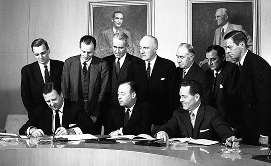 Black and white image of stock shares signing event