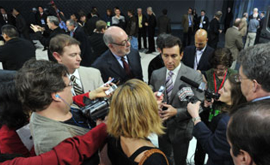 Photo of Mark Fields surrounded by reporters