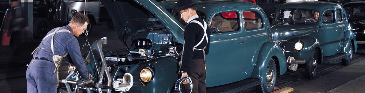 two line workers and two teal vehicles