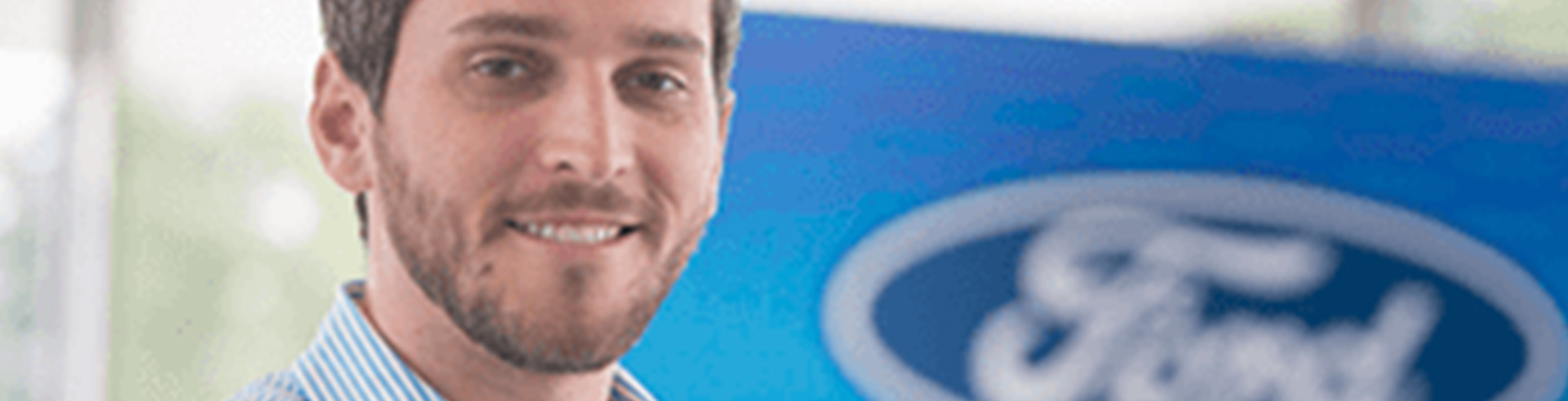 Male employee smiling for camera