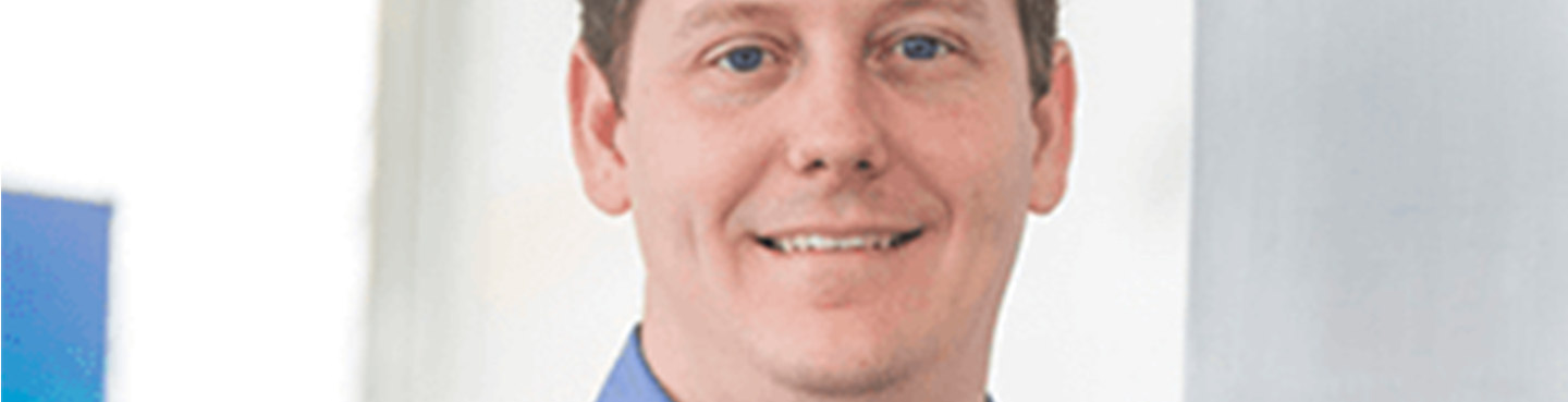 Male employee smiling for camera