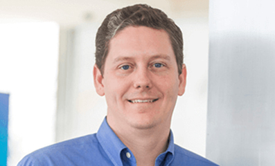 Male employee smiling for camera