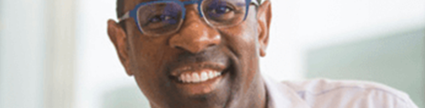 Male employee smiling for camera