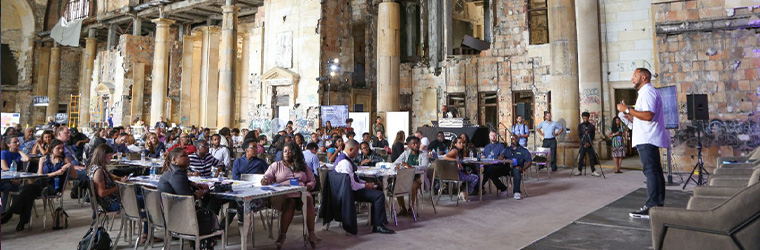 A speaker talking to a large group of people
