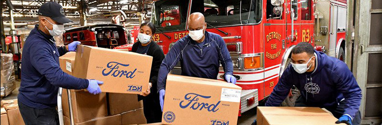 Employees lifting Ford boxes