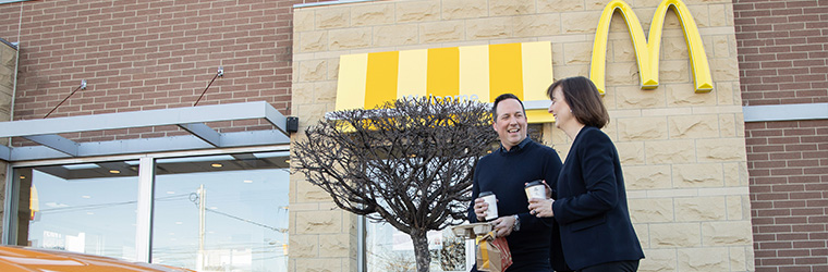 Two people outside of a McDonalds