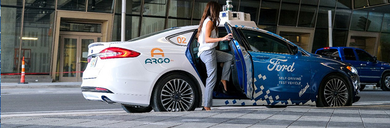 A person stepping into an Argo self-driving vehicle