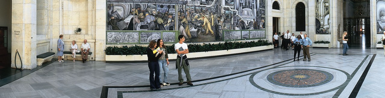 Men and women in ornate entry way of building
