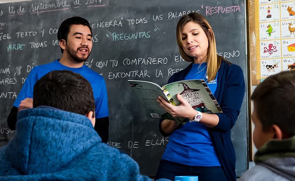 Image of man and woman reading in a classroom