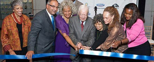 Ford Motor Company Fund and Community Services President Jim Vella joins Former U.S. President Jimmy Carter and others for a ribbon cutting ceremony.