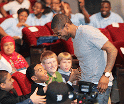 Usher Shaking Hands with Students