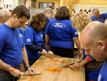 Ford volunteers serve meals.