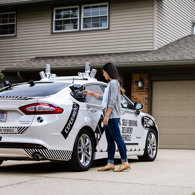 A self-driving vehicle delivering a package