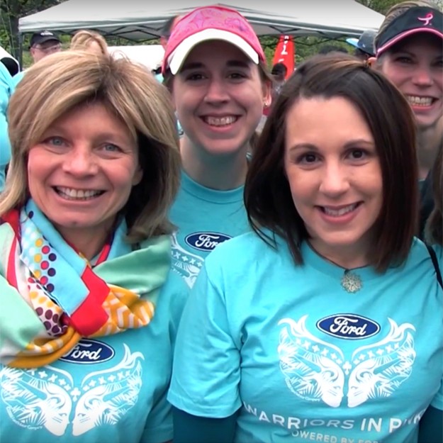 Three women wearing Warriors in Pink shirts