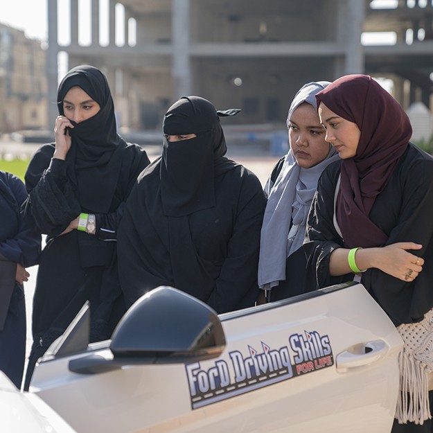 Ford Driving Skills - Women looking into a vehicle