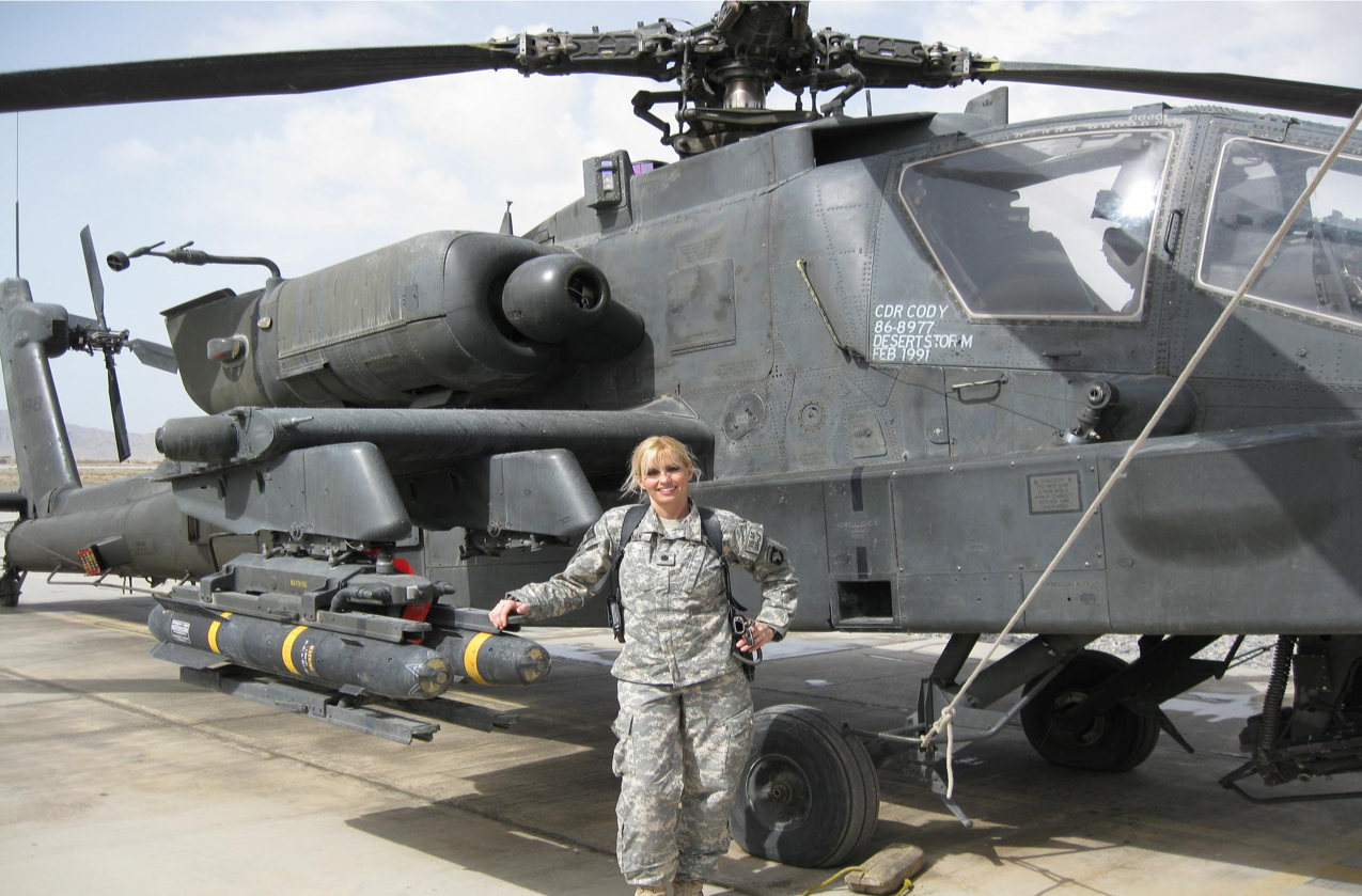 Colonel Benson in front of a helicopter
