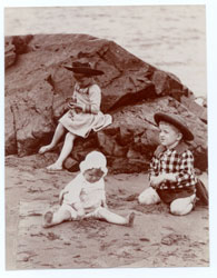 Image of two children and a baby at the seashore, retouched.