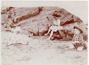 Image of two children and a baby at the seashore.