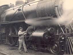 Image of: "Oiling Up Before the Start", Engineer Working on Michigan Central Railroad K Class Locomotive